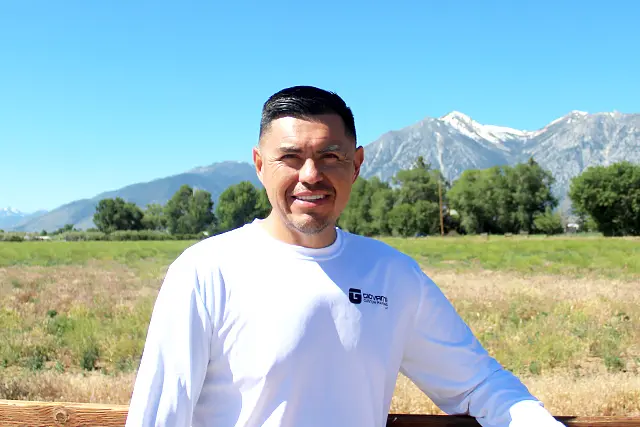 man posing in front of mountains